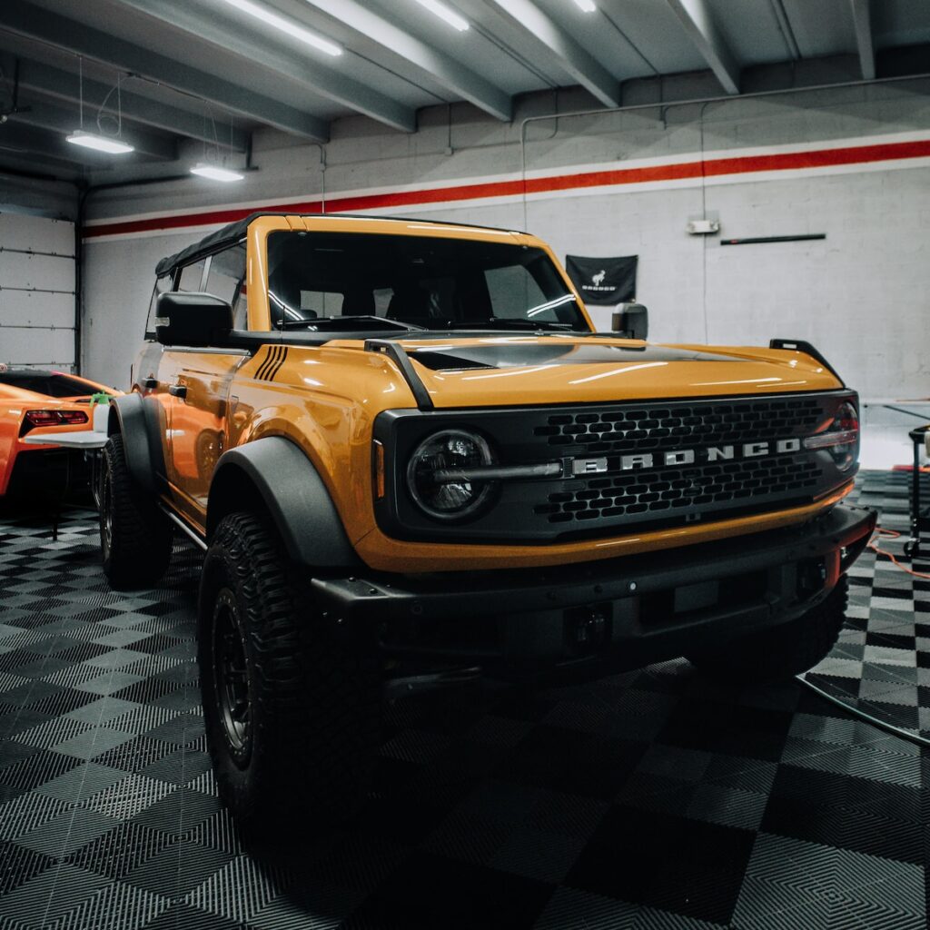a yellow truck is parked in a garage